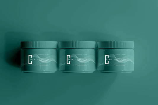 three jars of toothpaste on a green background