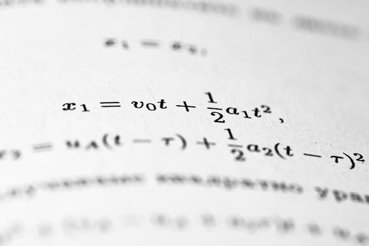 Mathematical formulas are written on the paper